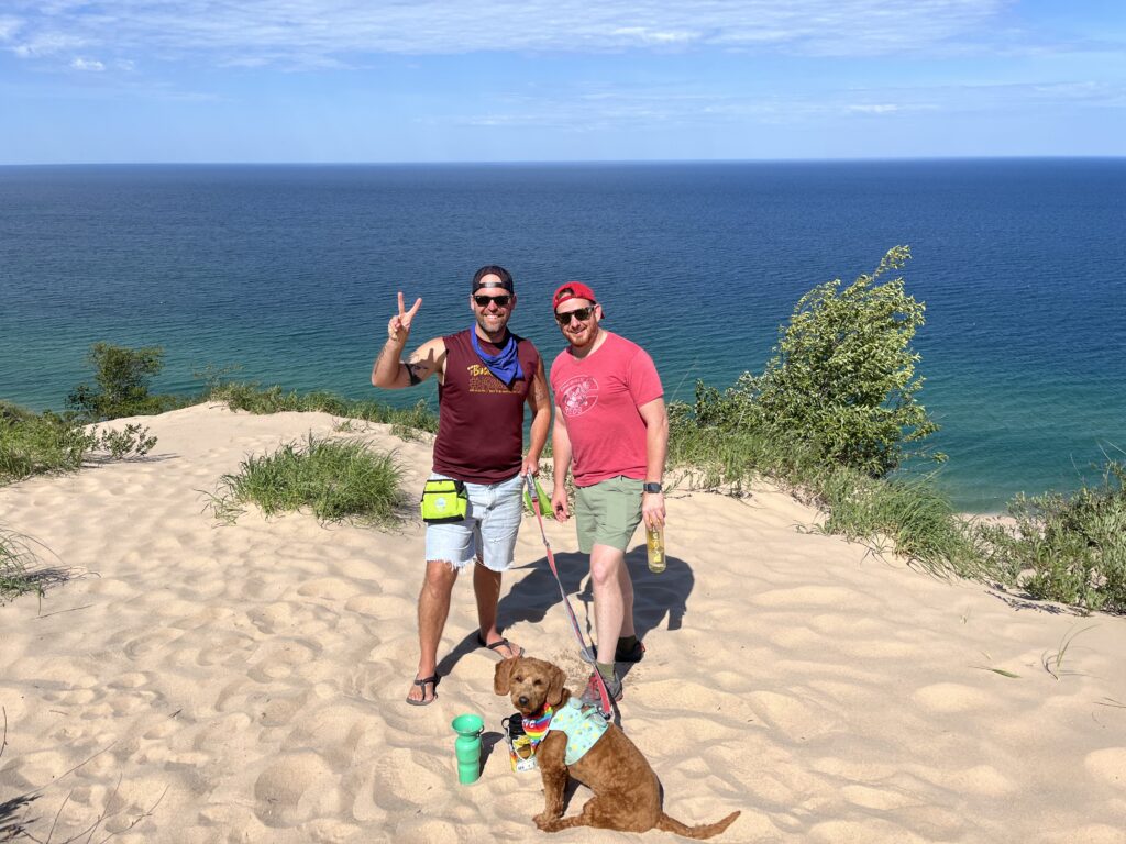 Hiking the dog friendly Arcadia Dunes with Lake Michigan in the background.